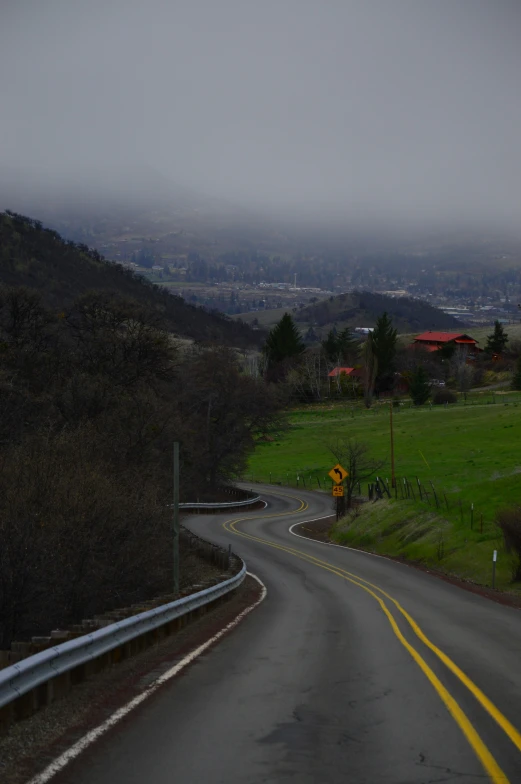 an image of an empty highway on a foggy day