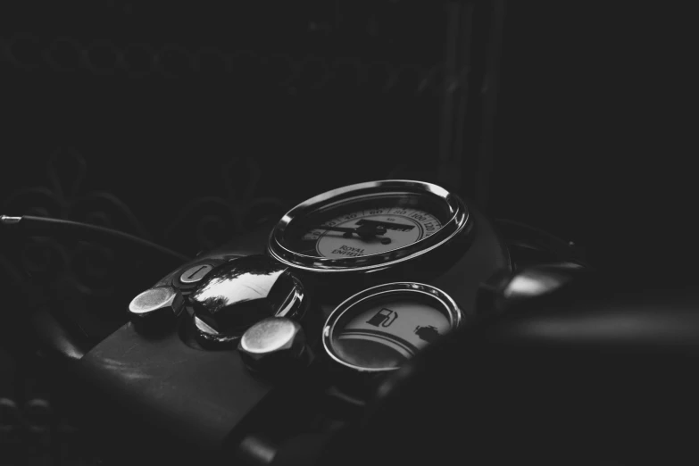 black and white image of a dial clock and spoon