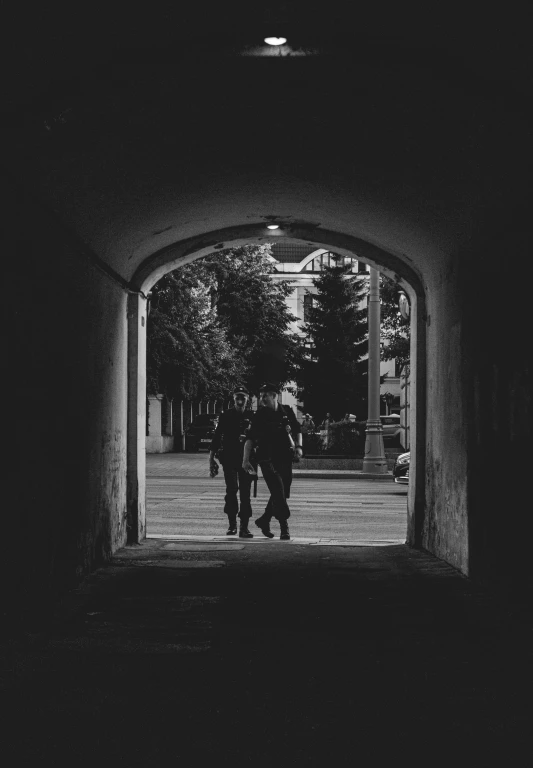 two people walk in an open archway