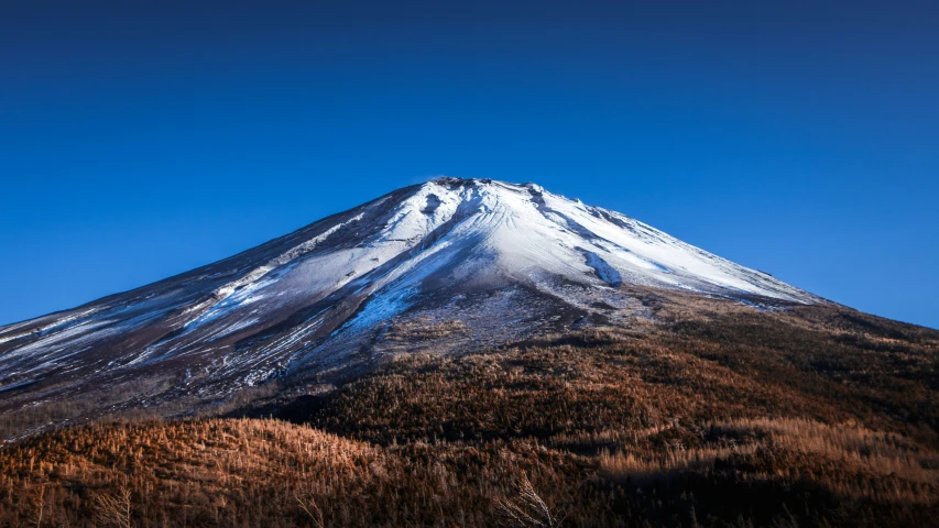 a very tall mountain with snow on top