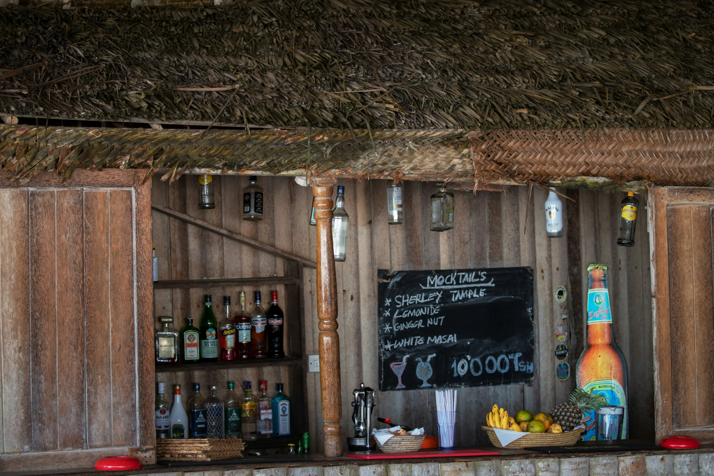 an outdoor bar with a large chalk board