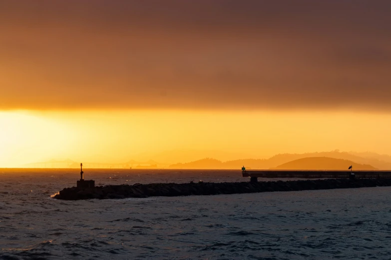 a sunset over a harbor and the sky