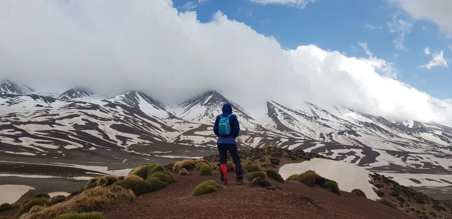 a man with his arm extended is on top of a hill