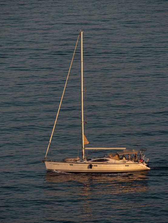 a small sailboat on a lake during the day