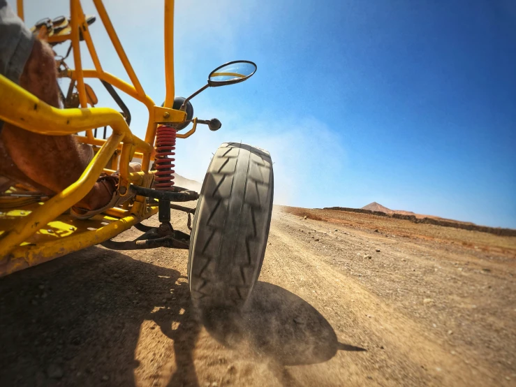 a motorcyclist driving in the desert on dirt