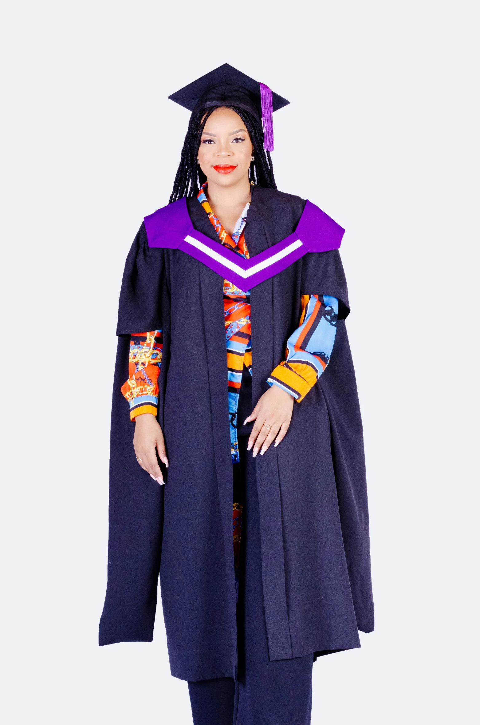 a woman in her graduation gown poses for a po