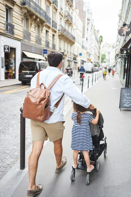 an adult is hing a child in a stroller