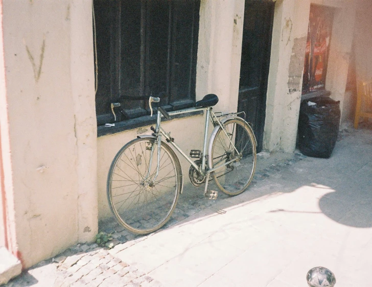 a bicycle parked outside of a building next to a window