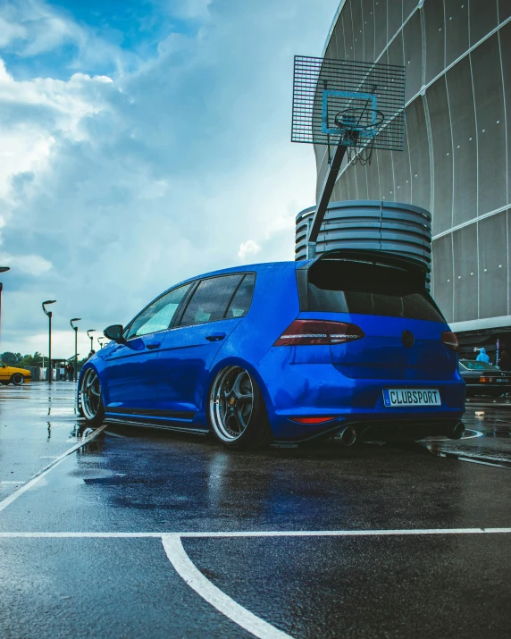 the back end of a blue volkswagen golf gte parked in a parking lot