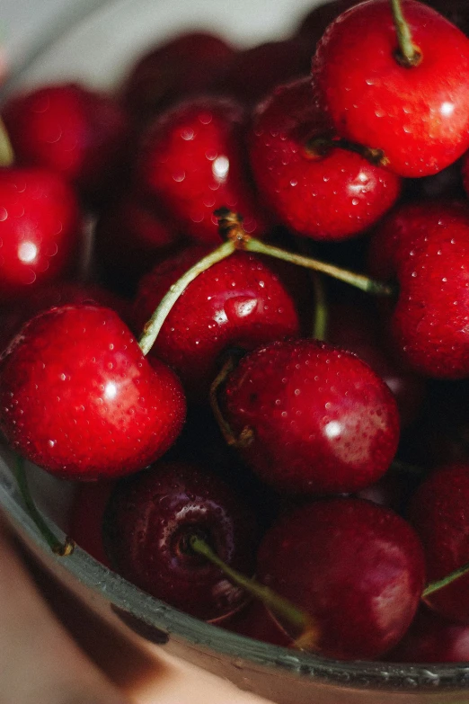 a small bowl filled with cherries that are shiny