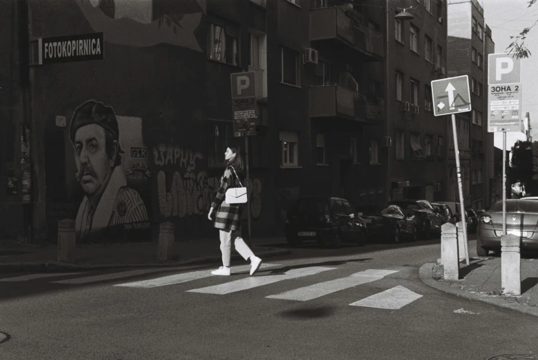 a woman wearing all black walking down the street