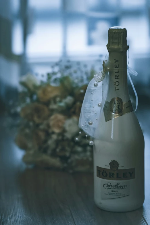 a bottle with some liquid sitting on top of a table