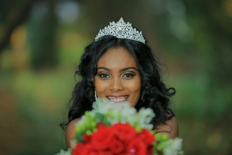 a woman wearing a tiara with roses in her hand