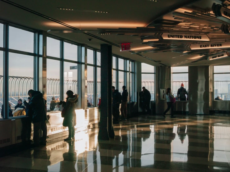 a large lobby with multiple windows and lots of people