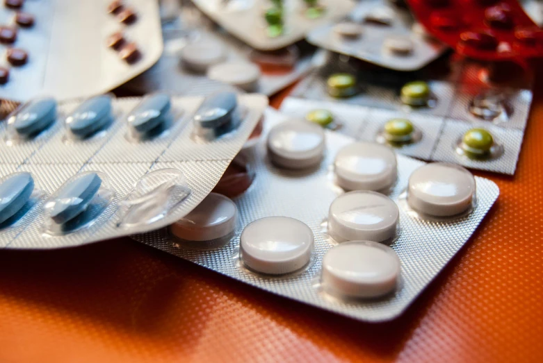 two plates sitting on top of one another filled with white pills