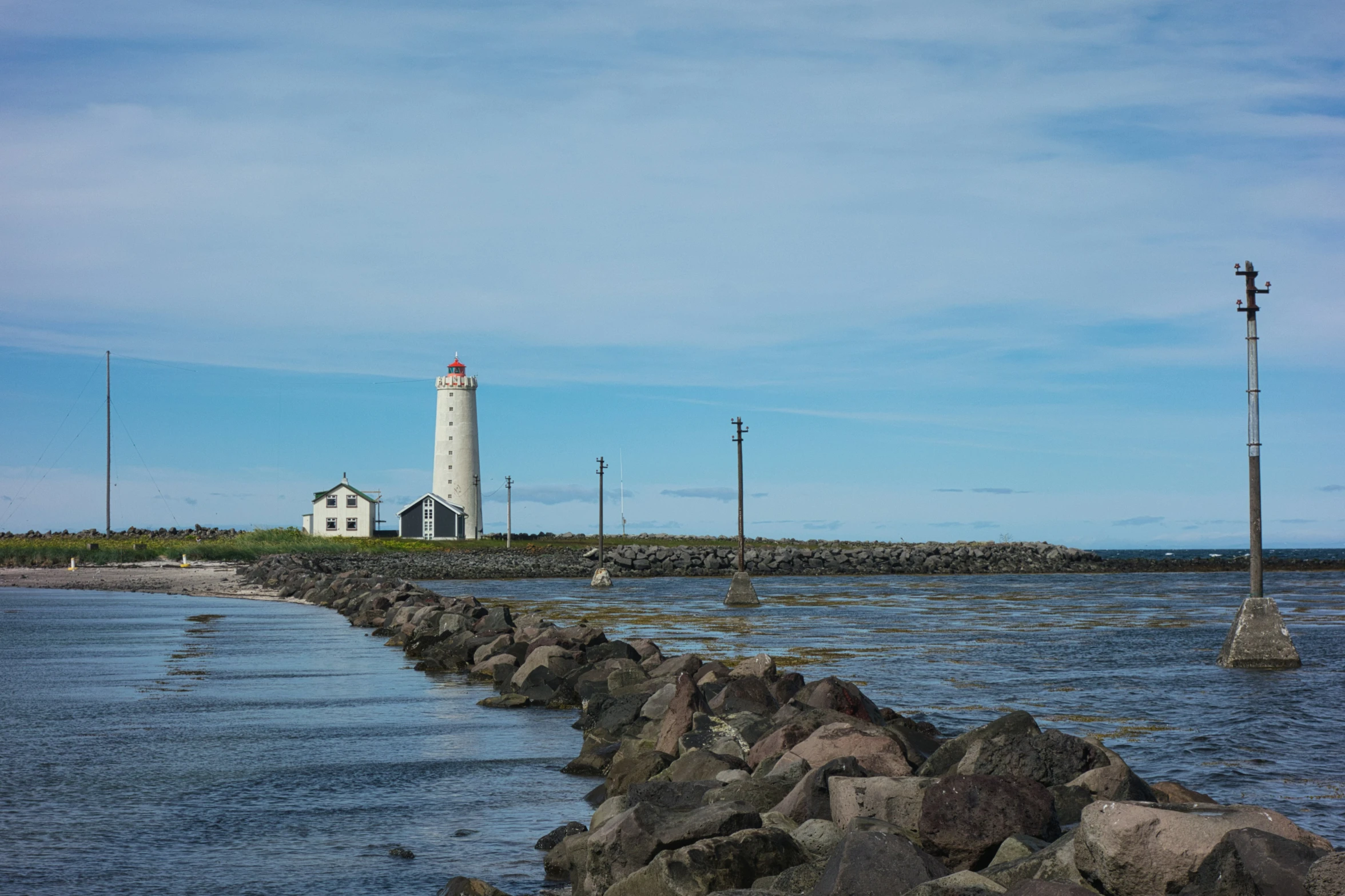 a long view of a lighthouse from across the water