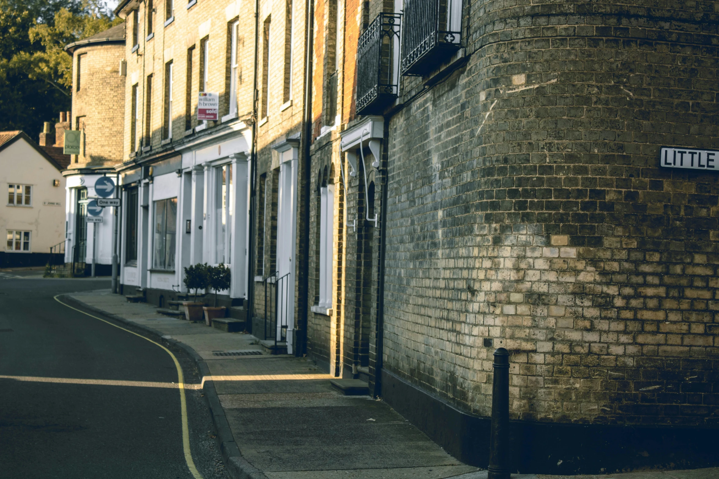 a brick building on the side of a street