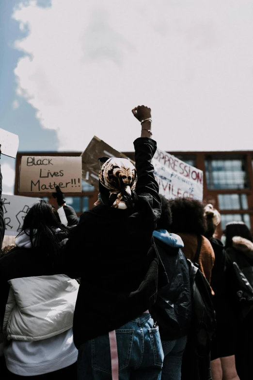 a group of people holding up signs and pointing