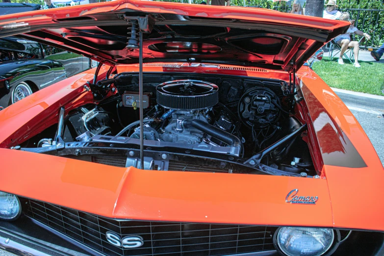 an orange car with the hood up