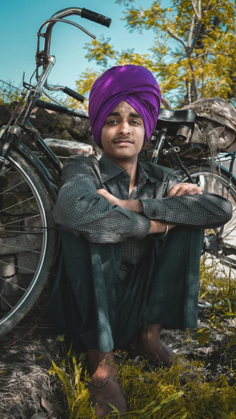 a man in turban sitting by his bike