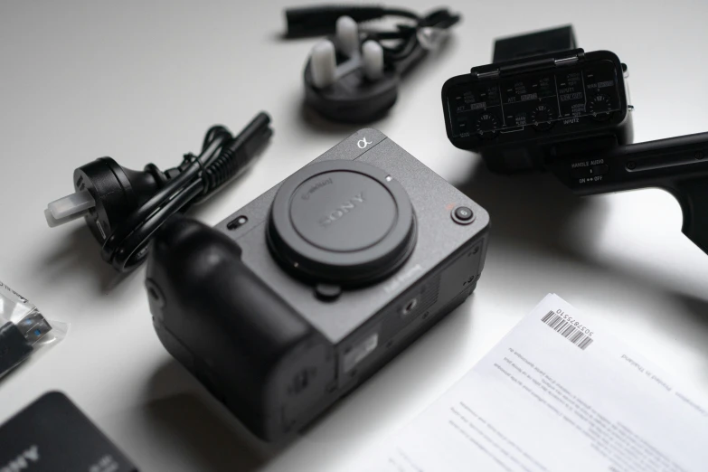 a black camera sitting on top of a table next to some cards