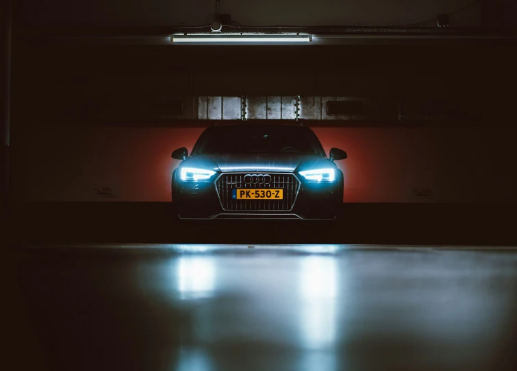 an illuminated mercedes c - class at night in the garage