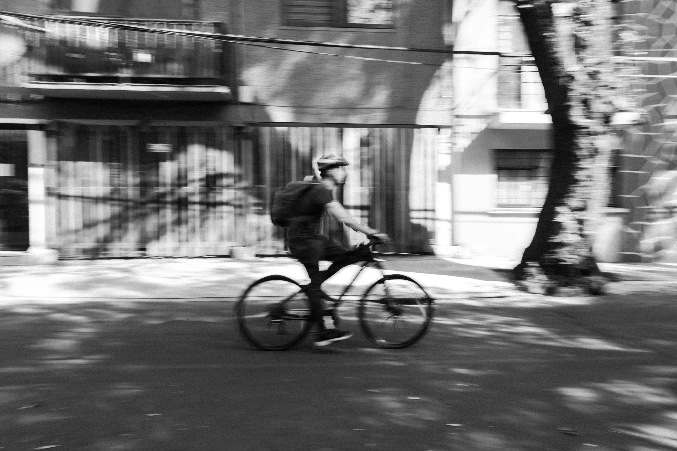 a man riding a bike in the middle of a street