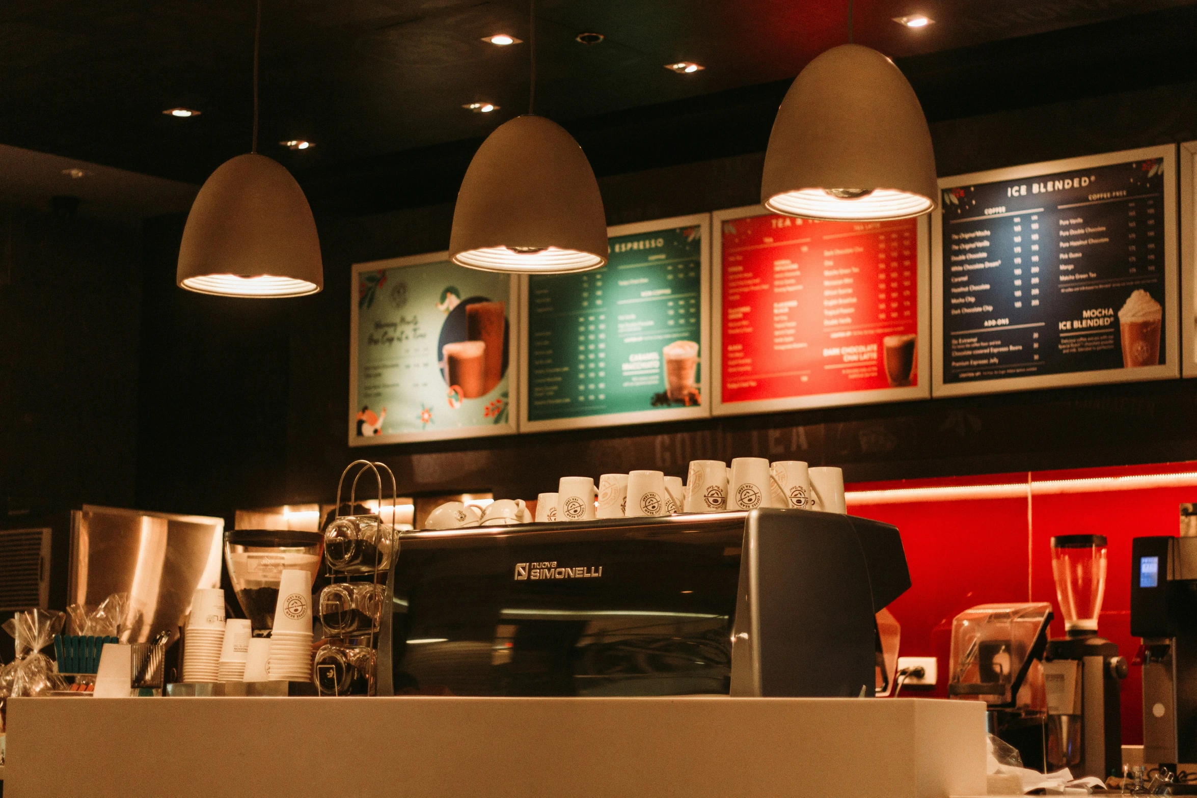 a coffee shop with signs over the counter