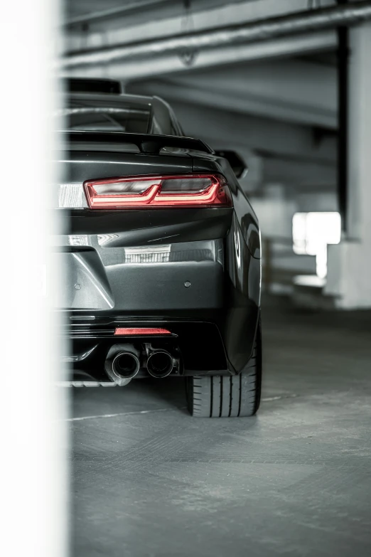 a car parked in a garage behind another car