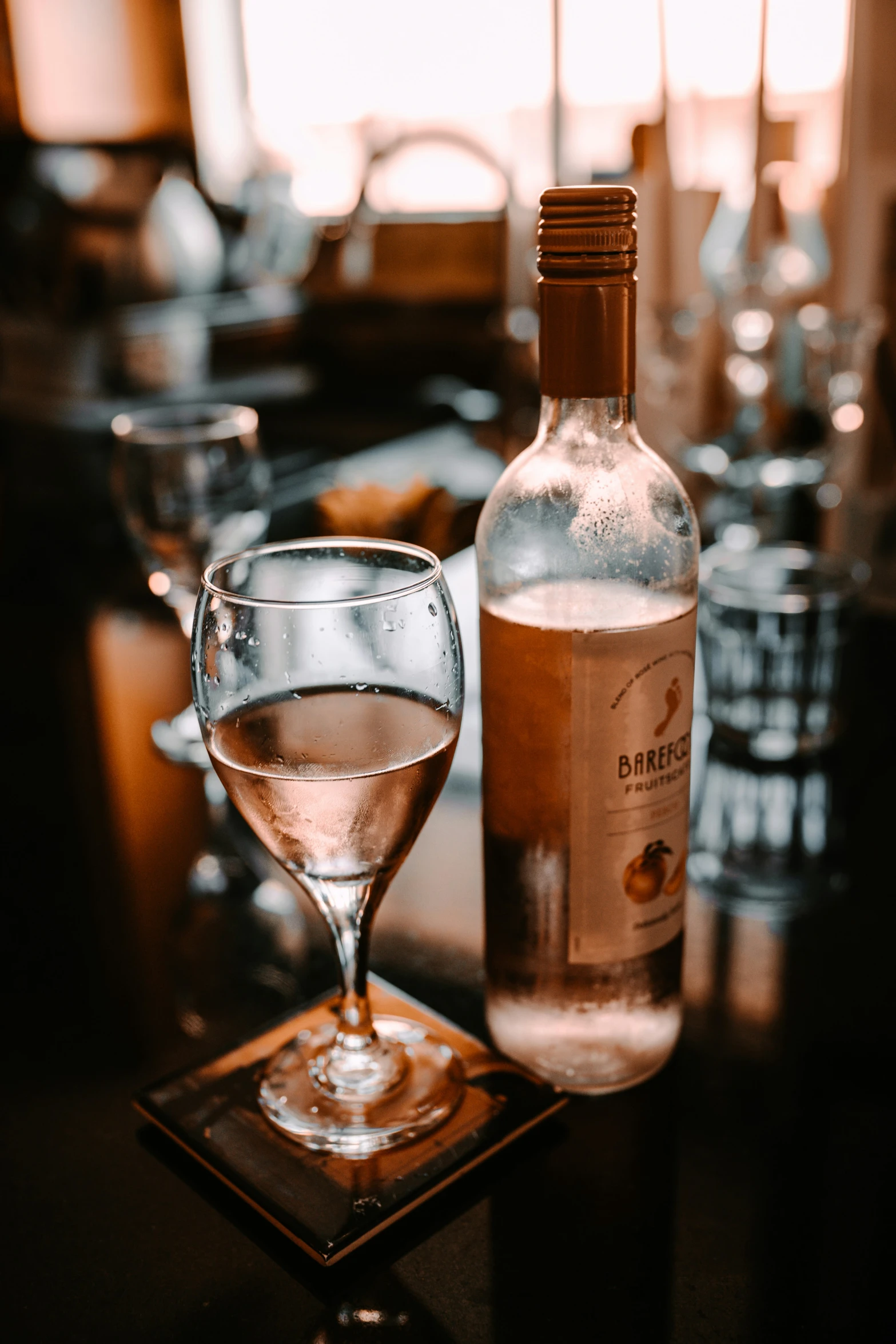 a bottle of ginneir next to a glass of wine