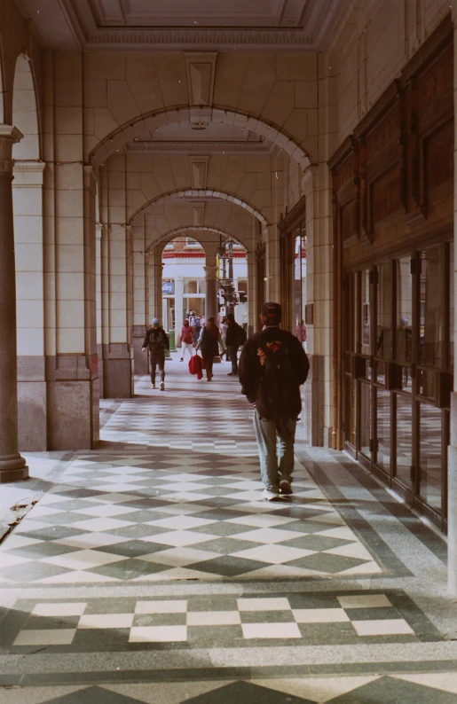 a man walking in an open area with two poles