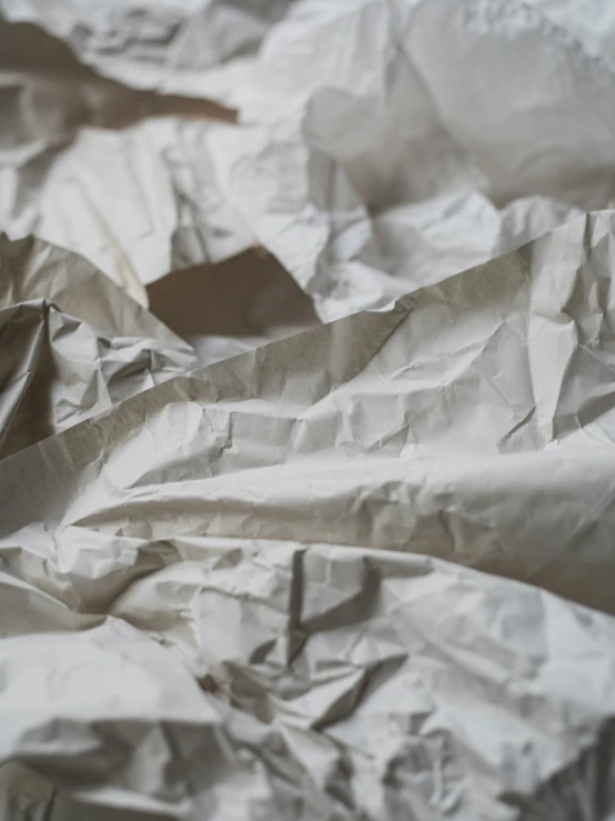 a bunch of wrinkled white paper on a table