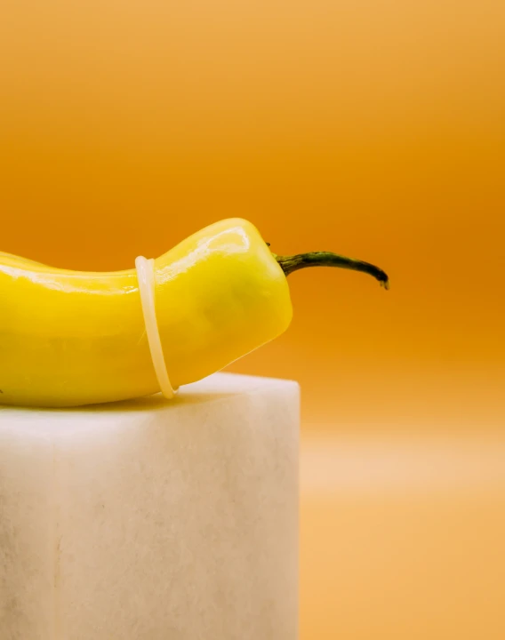 yellow banana sitting on top of a large pillar