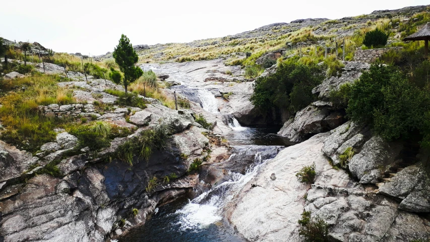 there is a small waterfall in the middle of this rock formation