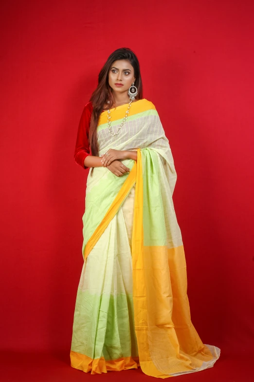 a model in yellow and green cotton saree