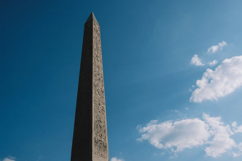 a tall memorial that is sitting under a cloudy blue sky