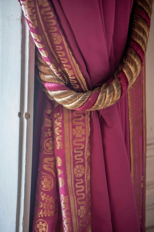 a close up view of a maroon and gold scarf