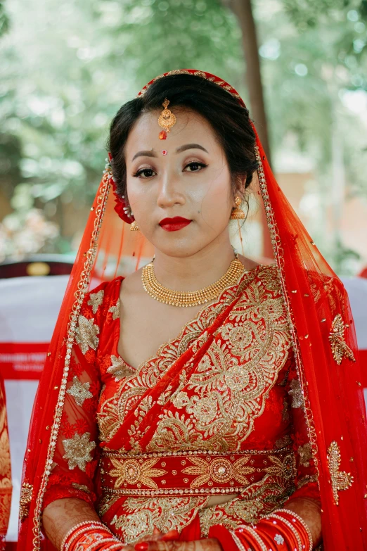 a woman dressed in an indian bridal outfit