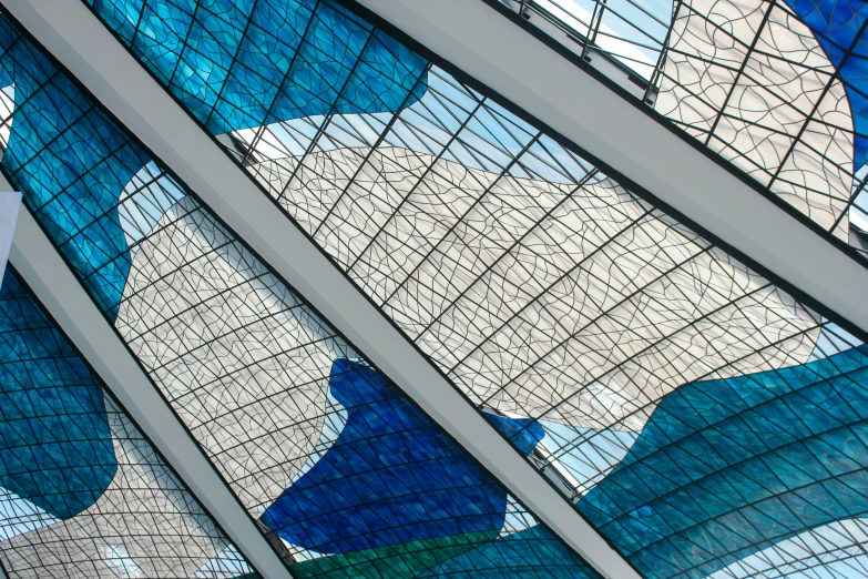 a blue and white wall with a variety of glass patterns