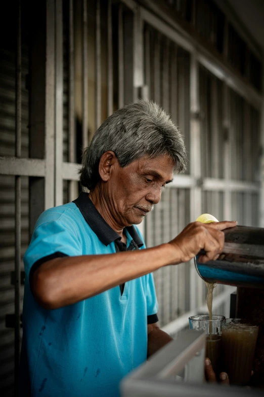 a person pouring soing in to a jar