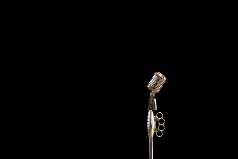 an old microphone and a black background