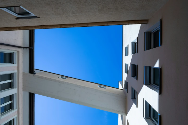 a window and wall looking up at the blue sky