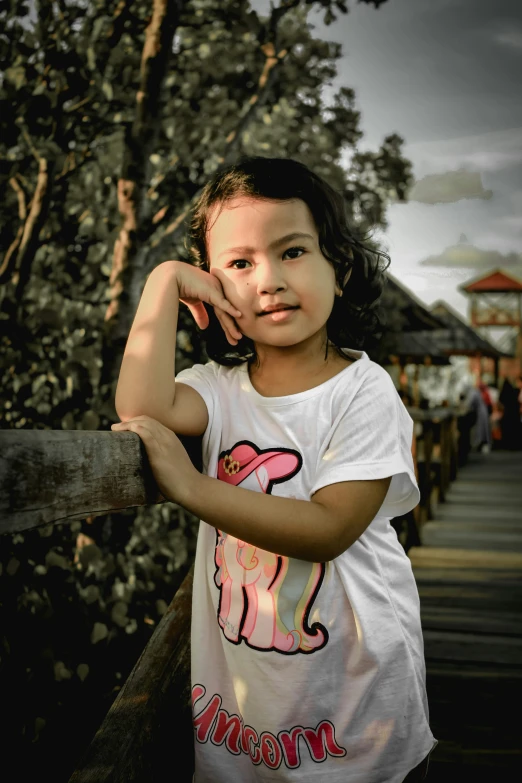 a small child leaning on the edge of a railing