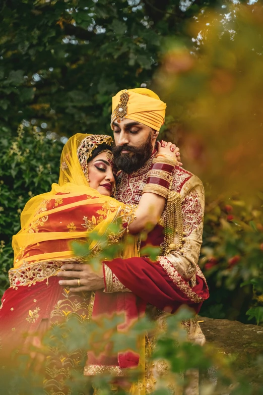 an indian couple emcing each other in their colorful wedding attire