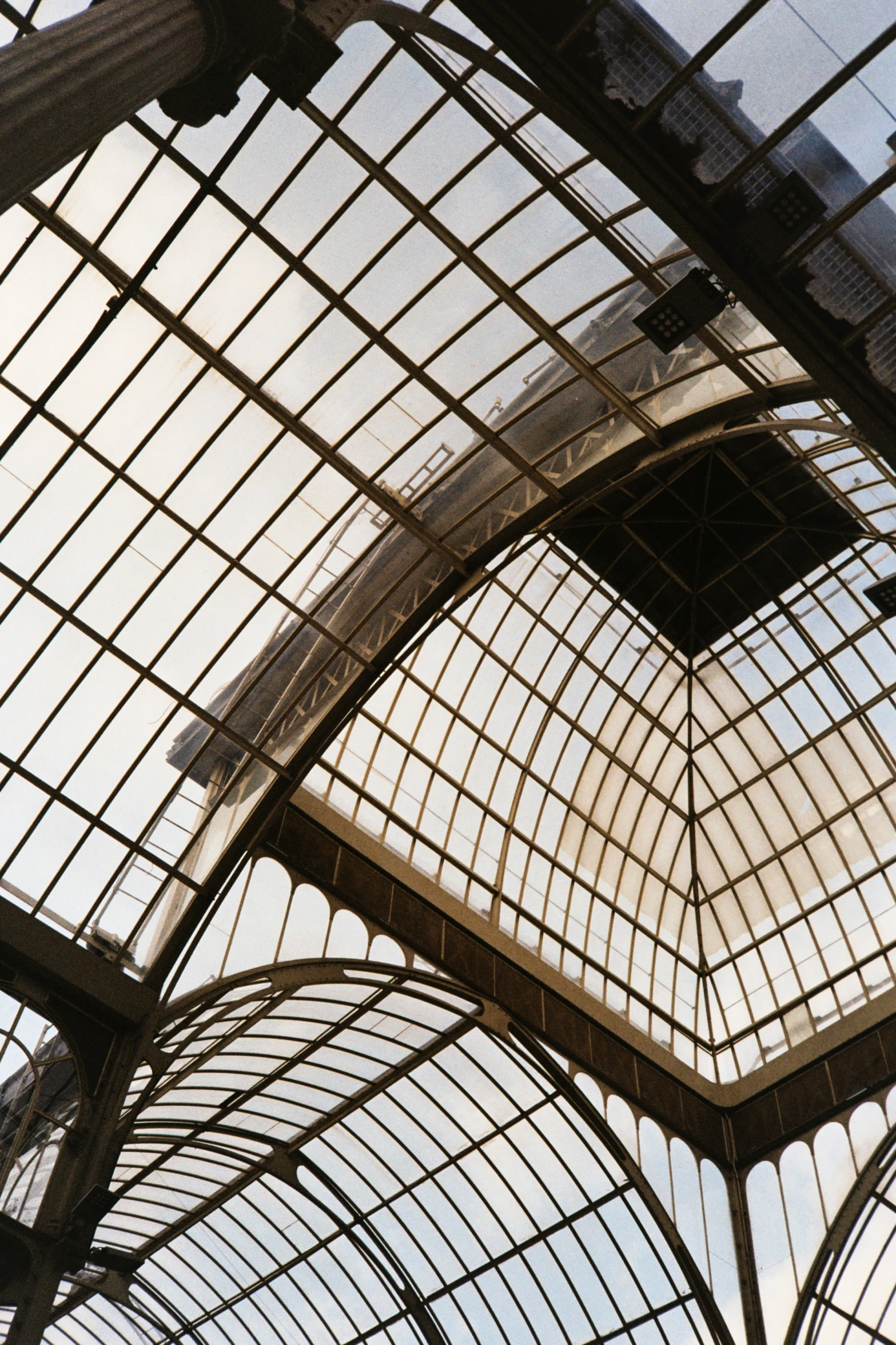an architectural glass roof over a railway station