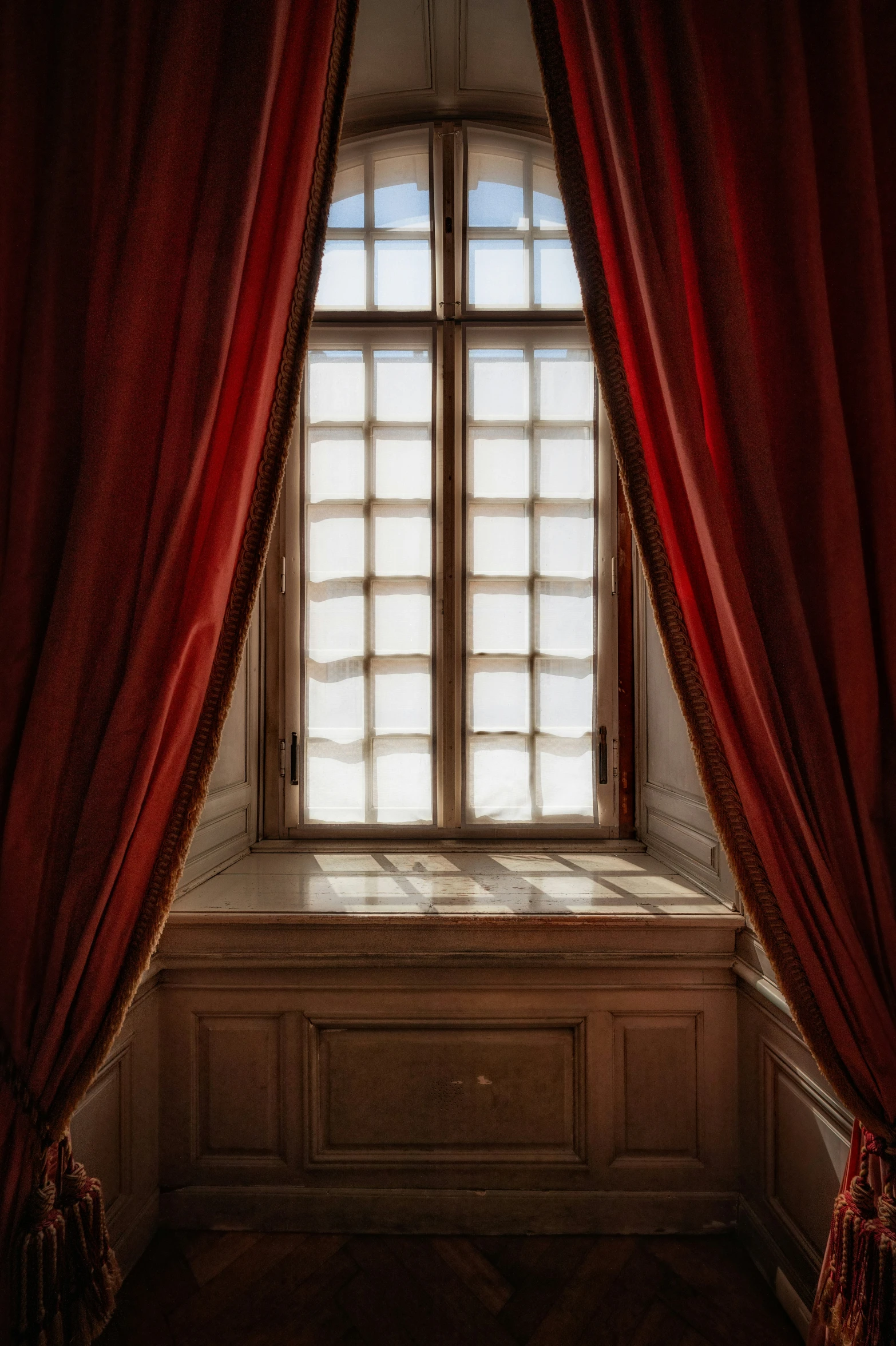 an open window that is sitting in front of a curtain