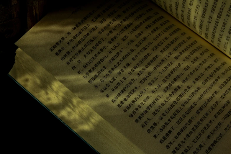 a shadow of a clock is cast onto an open book