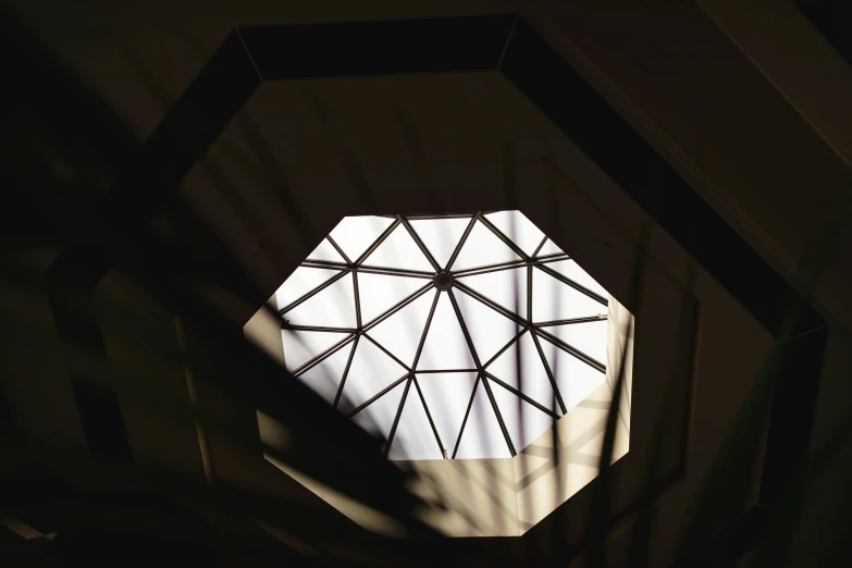 a close up view looking up at the ceiling from an octagonal window