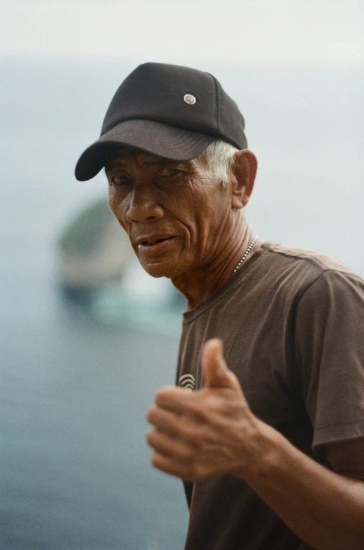 a man walking near the water on a cloudy day