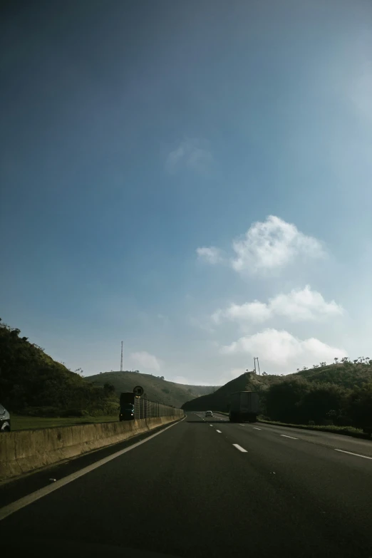 the side of a road with a traffic light in the foreground